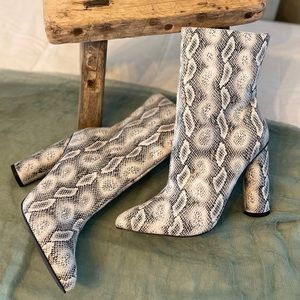Woman’s snake print above the ankle booties